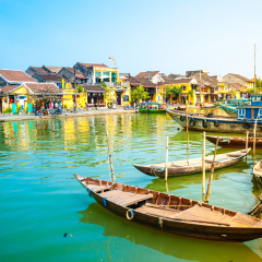 Traditional boats in front of ancient architecture in Hoi An, Vietnam. Hoi An is the World's Cultural heritage site, famous for mixed cultures & architecture.