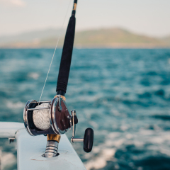 Boat fishing rods over a beautiful cloudy seascape horizontal