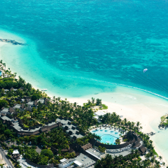Aerial picture of the east coast of Mauritius Island. Flying above the turquoise lagoon of Mauritius in the region of Belle Mare