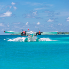Exotic scene with seaplane on Maldives sea landing. Vacation or holiday in Maldives concept background