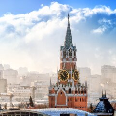 Moscow city historical skyline winter aerial view snow building street kremlin spasskya tower red square smoke church residential building roof russian winter theme close up