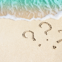 question mark sign handwritten in sand beach