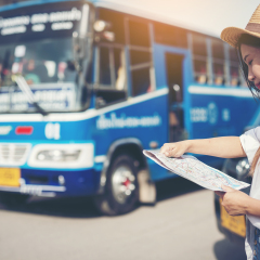 happy female tourist on map  to Bus station vacation.,Welcome  to Chiang Mai.Travel concept.