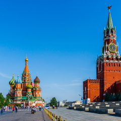 Red Square of Moscow in the summer evening. Red wall of the Kremlin, Spassky (Savior's) tower and St. Basil's cathedral. Soviet era viewing stand (right) to watch civilian and military parades