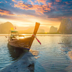 Beautiful sunset at tropical sea with long tail boat in south thailand