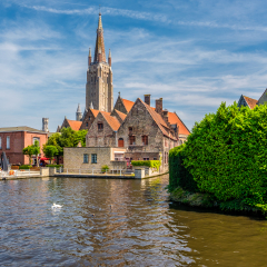 Bruges (Brugge) cityscape with water canal and Church of Our Lady, Flanders, Belgium