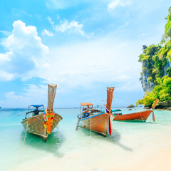 Longtale boat on the white beach at Phuket, Thailand. Phuket is a popular destination famous for its beaches.
