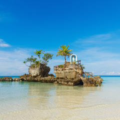 Willy's rock with the statue of the virgin Mary, Boracay island, Philippines. Tropical sea in the background.