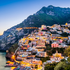 Sunset view of Mediterranean sea and beautiful Positano village at Amalfi Coast, Italy.