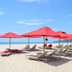 beach chair and Red Umbrella on the Bang Tao beach , Phuket in Thailand