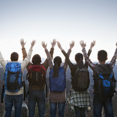Group of people standing with hands outstretched