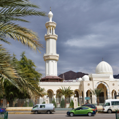AQABA, JORDAN - MARCH 14, 2014: People near the Al Sharif Hussein Bin Ali mosque in a springtime day. The mosque was built in 1975 and in 2011 was renovated and enlarged