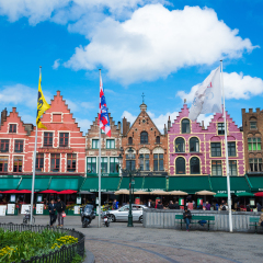 Bruges, Belgium - April 17, 2017: Tourists in north side of Grote Markt - Market Square of Bruges, Brugge, with enchanting street cafes, meeting place of the Brugelings and tourists.