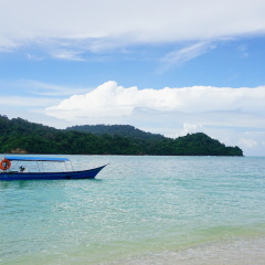 Langkawi, Malaysia - July 13th, 2017. Tourist spend time at a beach in Pulau Beras Basah in Langkawi in sunny day. 
