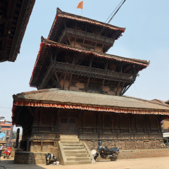 BHAKTAPUR, NEPAL - APRIL 20, 2016: people, goats ans vehicles around Dattatraya Temple in Tachupal Tole square, Bhaktapur, Nepal.