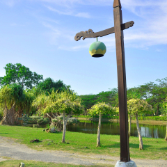 Designed wood pillar lamp among green park and blue sky in Langkawi Legend park.This park located at Langkawi, Kedah, Malaysia