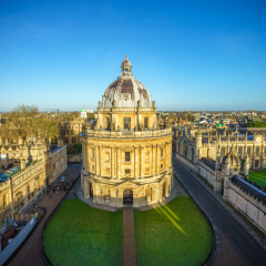 Aerial view of the Oxford University City viewed from in the top tower of St Marys Church at sunrise. All Souls College, United Kingdom, England. Panoramic view