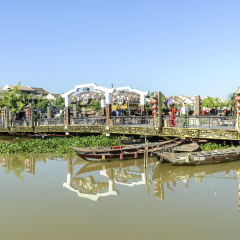 boats reflexes and bridge in the river Thu bon in the Hoi an town in Vietnam.