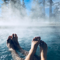 Couples Feet in Hot Tub Jacuzzi Spa Outdoors with Mist Romantic Getaway