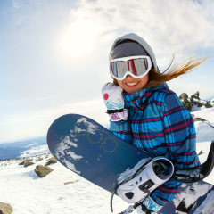 Girl snowboarder enjoys the ski resort. Sheregesh. Russia.