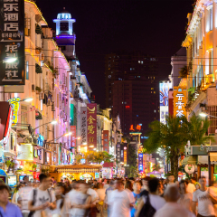 XIAMEN, CHINA - JUNE 11, 2014: Pedestrians walk on Zhongshan Road at night. The road is the main commercial street in Xiamen and parts have been fully pedestrianized.