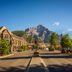 BANFF, ALBERTA, CANADA - JUNE 27, 2017 :  Scenic street view of the Banff Avenue in a sunny summer day. Banff is a resort town and popular tourist destination.