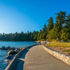 VANCOUVER, BC/CANADA - JULY 30: People at Stanley Park Seawall in Vancouver, Canada on July 30, 2015. Park visitors walk, bike, roll, and fish on the 22 kilometers seawall route.