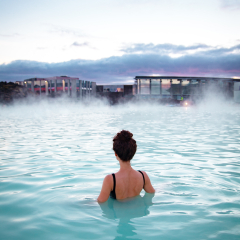 Woman relaxes and enjoys of spa in hot spring Blue Lagoon in Iceland
