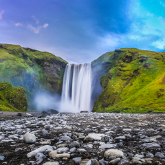 Classic long exposure view of famous Skogafoss waterfall in beautiful twilight during blue hour at dusk in summer, Skogar, south of Iceland