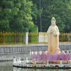 The  goddess of mercy guanyin buddha statue over water at Zhanshan Temple in Qingdao China in Shandong province.  