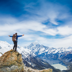 Hiker with backpack on the mountain top. Sport and active life concept