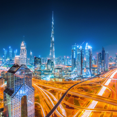 Dubai skyline at sunset with beautiful city center lights and Sheikh Zayed road traffic, Dubai, United Arab Emirates