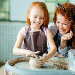 redhead mother and daughter mold with clay on pottery