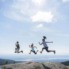 Three People Running and Jumping on Mountain Top, Cliff Edge