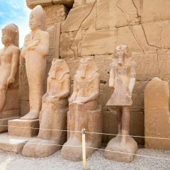 Statues of Thutmose III, unknown Dynasty 13 king, Sobekhotep and Amenhotep II near north side of seventh pylon. Karnak Temple, Luxor, Egypt, Africa