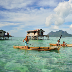 SABAH, MALAYSIA - APR 18: Unidentified Bajau Laut kids on a boat in Bodgaya Island on April 18, 2015. They lived in a house built on stilts in the middle of sea. 