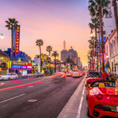 LOS ANGELES, CALIFORNIA - MARCH 1, 2016: Traffic on Hollywood Boulevard at dusk. The theater district is a famous tourist attraction.