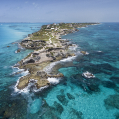 Isla Mujeres, Aerial View Punta Sur.   Crystal clear turquoise water,  waves crashing on the rocky shore, and the ruins of the temple of Ixchel.  