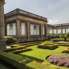 chapultepec, view of the garden and gazebo with a window with the Mexican state emblems, flower beds and flowers in the foreground