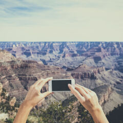 Caucasian woman photographing Grand Canyon, Arizona, United States