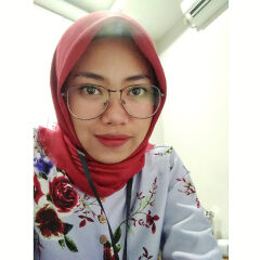 Portrait Of Smiling Young Woman Wearing Eyeglasses At Home