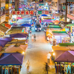 Hong Kong colorful stalls at busy night market street panorama China