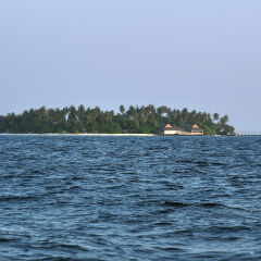 Maldivian Island Kuda Bandos Seen From A Boat