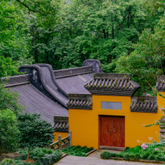 Buildings with yellow wall, red door, and black roof tiles in Lingyin Temple, Hangzhou, China