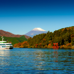 Red torii gate on the shore of Lake Ashi, near Mount Fuji in Hakone, Japan.