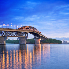 Auckland Harbour Bridge with its lights on, just before dawn.
