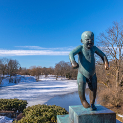 OSLO, NORWAY - APRIL 6, 2018: Oslo city skyline at famous Angry Boy Statue in Vigeland Sculpture Park, Oslo, Norway