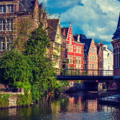 Travel Belgium medieval european city town background with canal. Ghent, Belgium. Retro vintage hipster style cross processed.