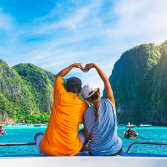 Happy couple traveler doing heart shape joy relaxing on boat Maya beach, Krabi Phuket, Travel adventure nature Thailand, Tourist beautiful destination place Asia, Summer holiday outdoor vacation trip