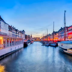 Nyhavn with its picturesque harbor with old sailing ships and colorful facades of old houses in Copenhagen, Denmark.
